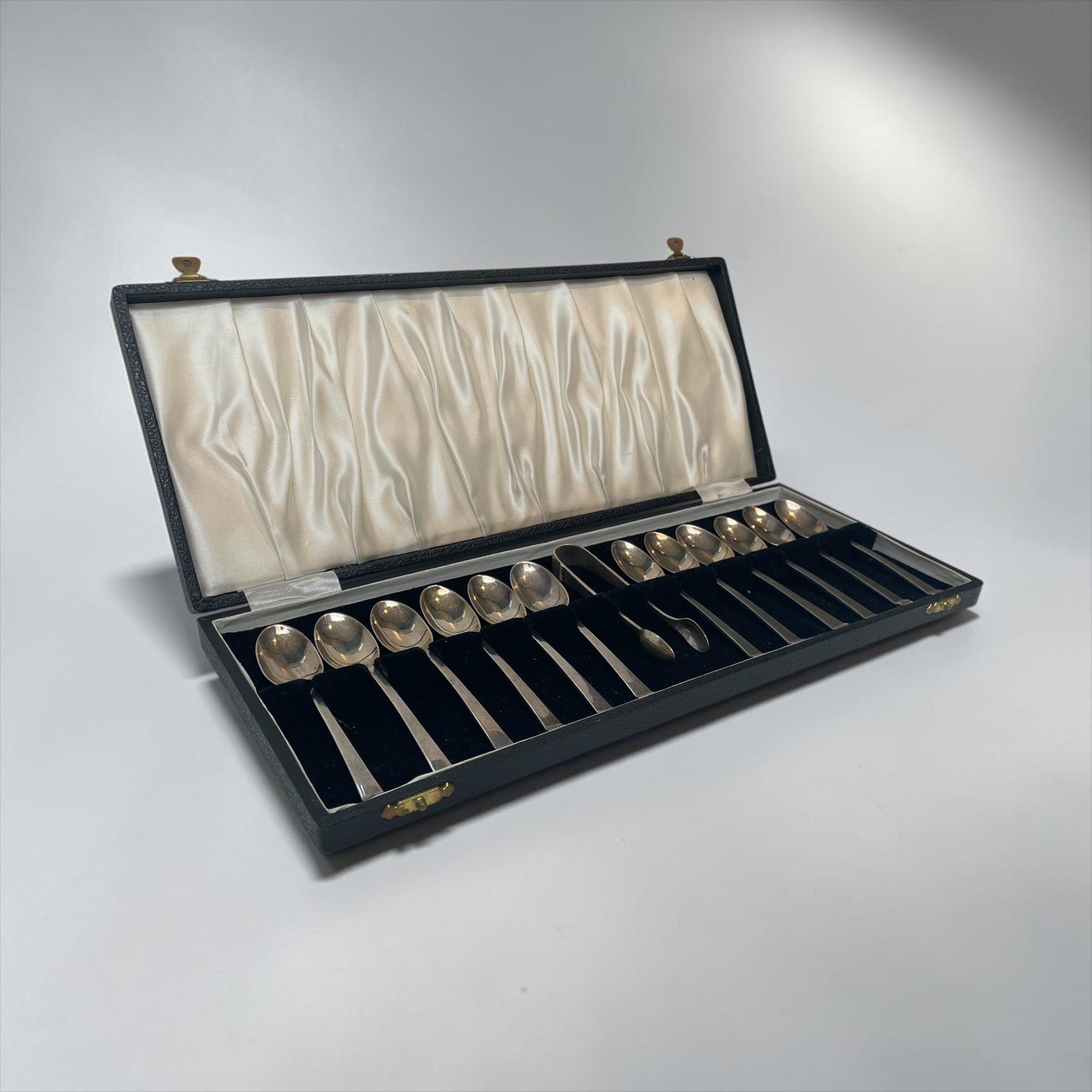 Set of Twelve Silver Teaspoons and Sugar Tong